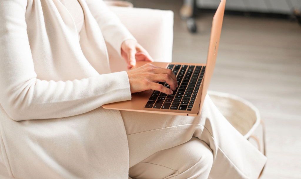 Copywriter typing on laptop.